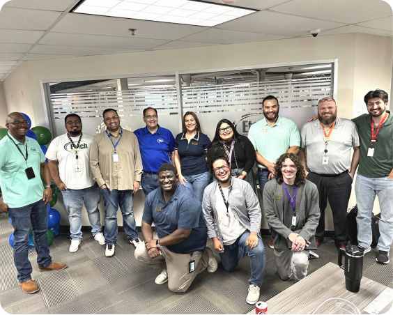 Group of Etech employees smiling together during a team celebration